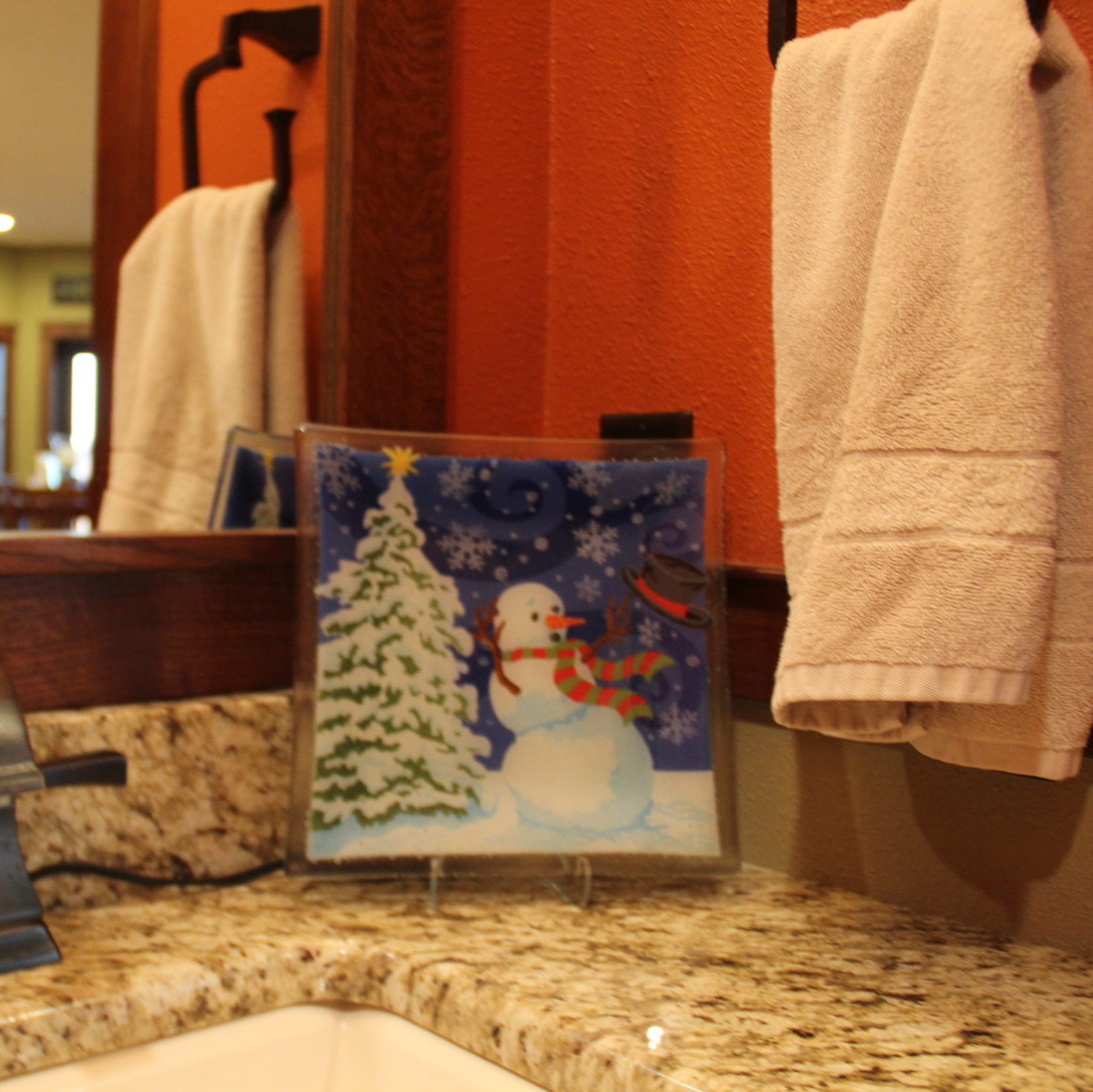 The Windy Snowman plate by Peggy Karr fits great in the powder room