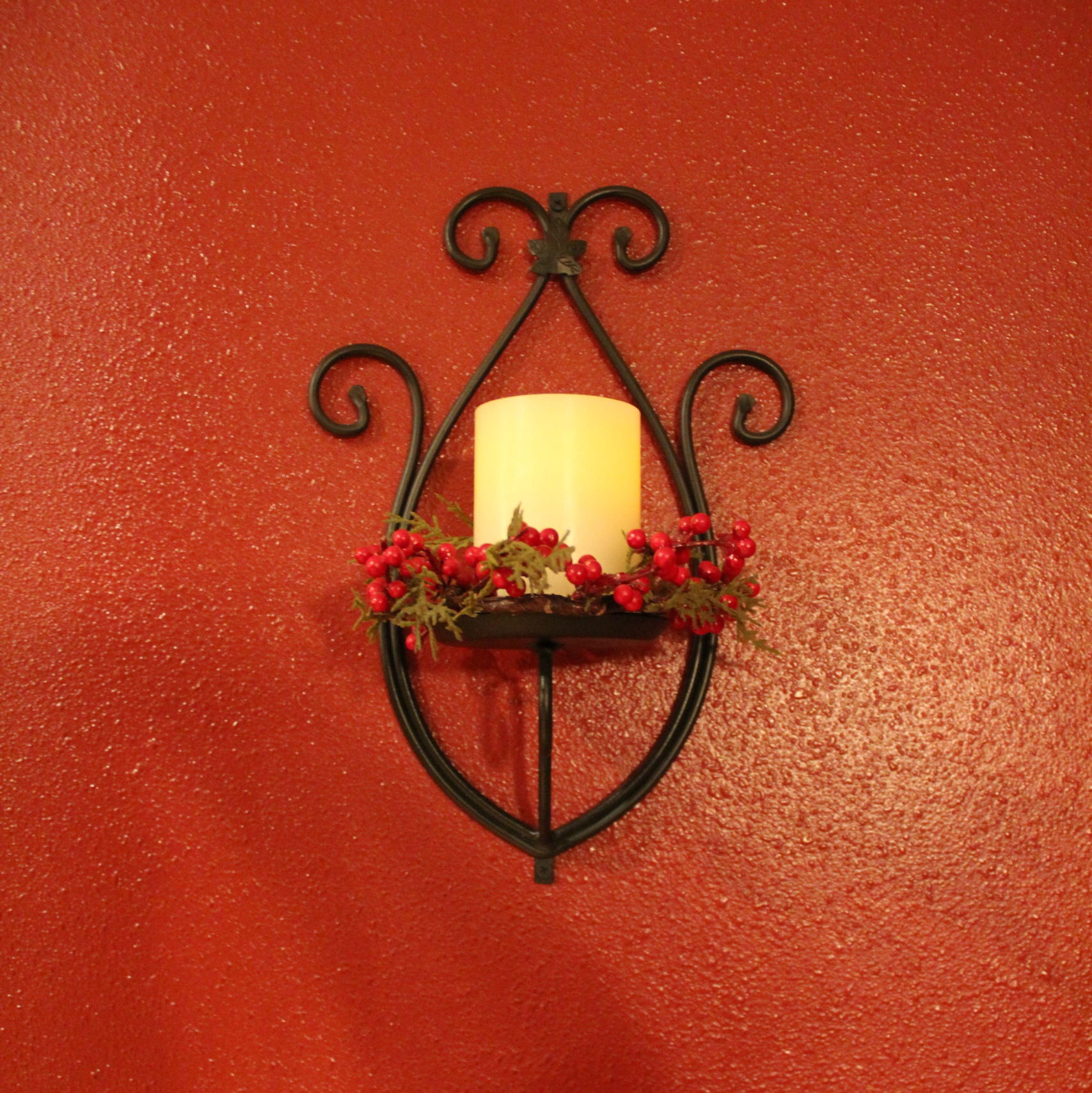 Wall sconces on the Waite wall get a pretty candle ring of Christmas greenery. Sconce is Longaberger with an automatic candle.