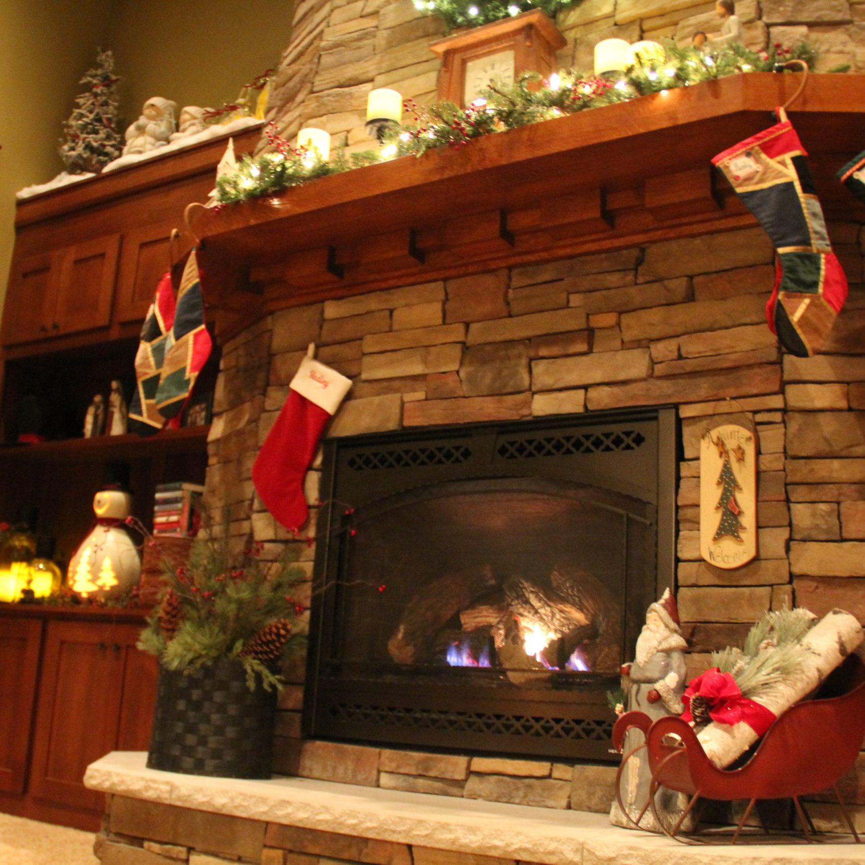 My Dave built mantle is perfect for the stocking hooks sold at LL Bean. How many stockings do I hang though. It was quite the decision. For Hadley I hung hers on a long nail between bricks and really love how it turned out.