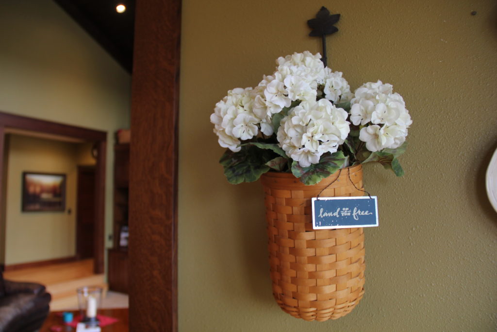 Brighten up this Longaberger basket with Spring like floral and a little tin sign.