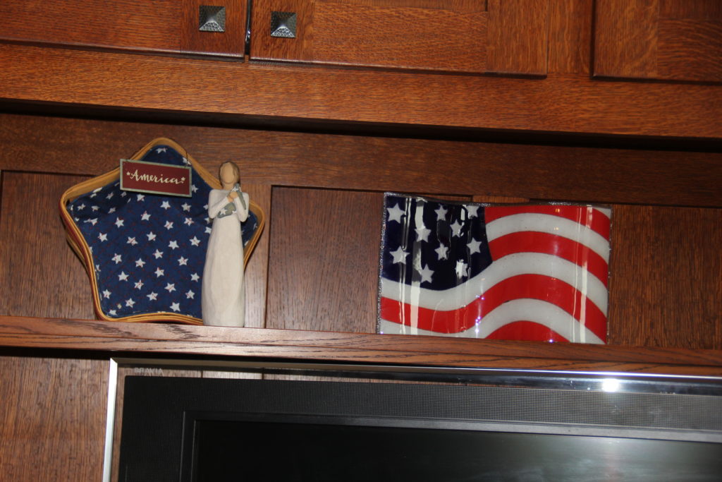 A mix of Americana decor. Peggy Karr flag plate, Longaberger and Angel.