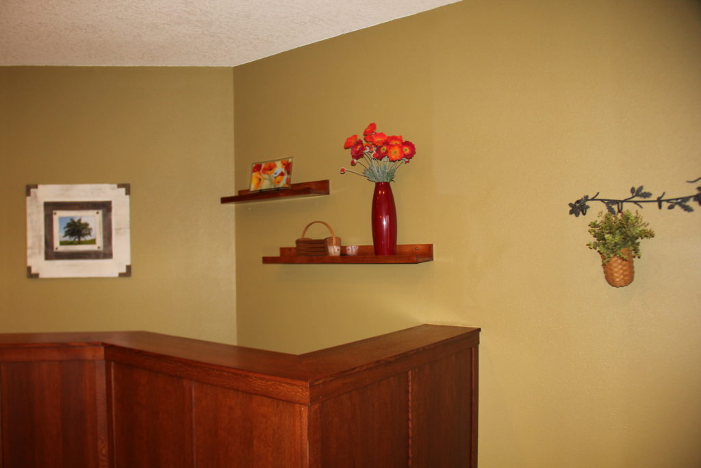 Front Entryway floating shelves brighten up with floral and different Peggy Karr plate