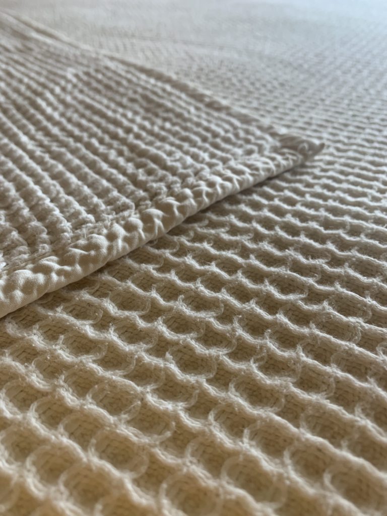 The waffle weave blanket by Boll and Branch is the perfect layer blanket. It does need to be washed every so often to reshape.