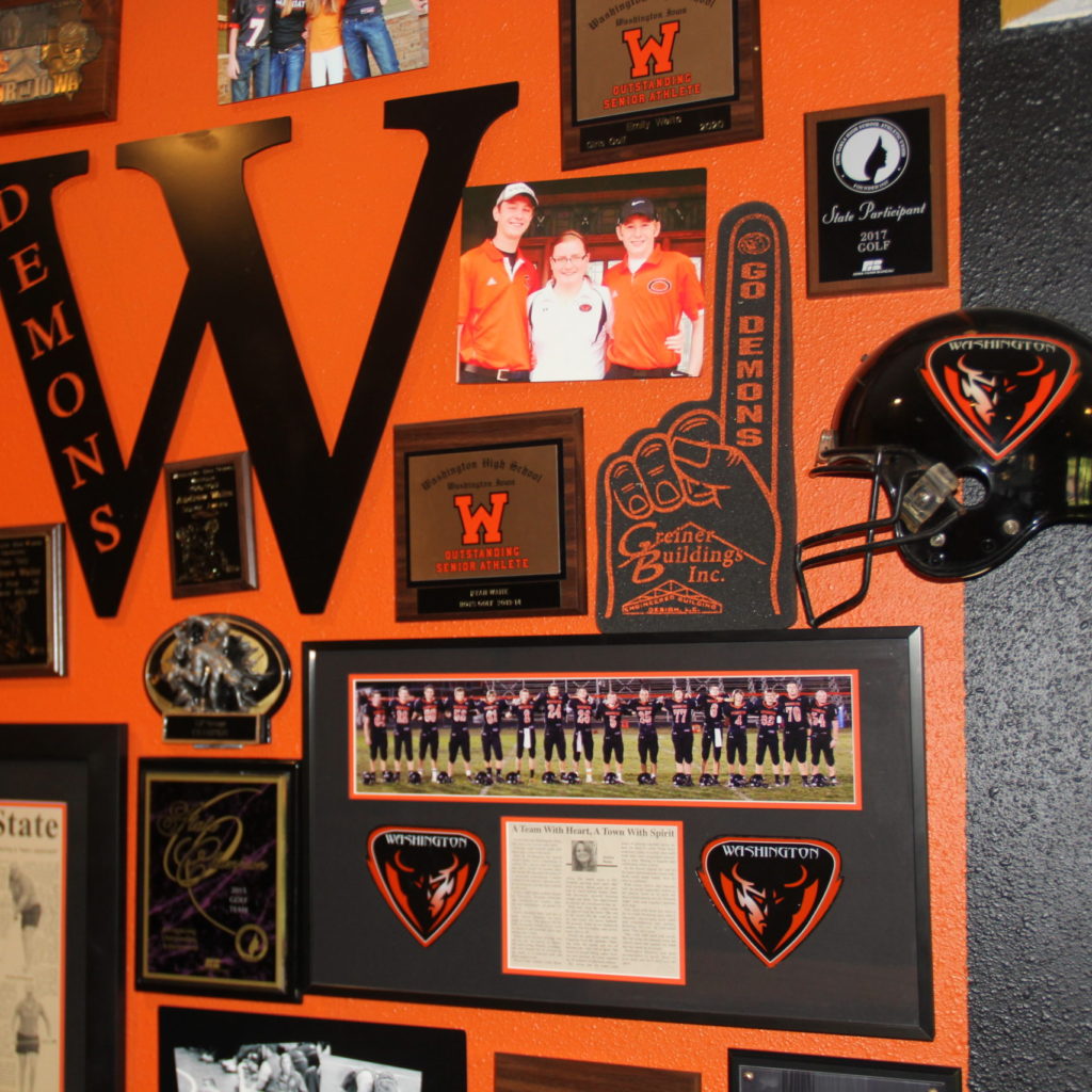 Custom framing including published articles and team pictures. Half a football helmet, foam finger and awards