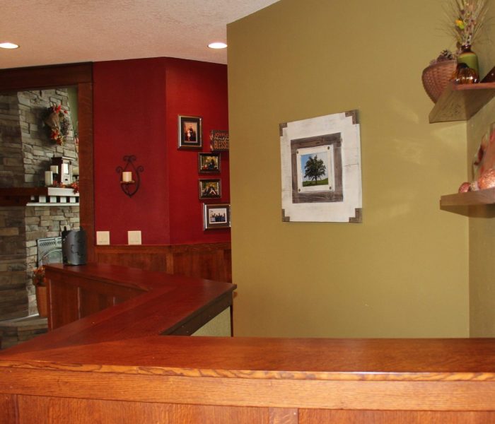 Entryway. The large picture frame holds a seasonal photo of the oak tree that was a mainstay here on the property that the farmer kept and planted around. It was one of the reasons we built the house on this end. I change the picture during winter when the tree is blanketed in snow.