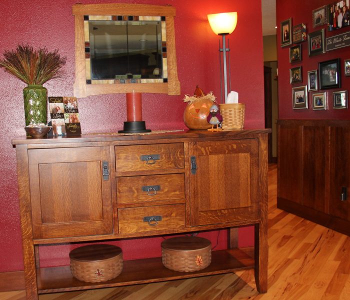 And here is another Dave made piece, a sideboard. Again I highlighted this wall with the burgundy paint color. I always try to stay in my theme of craftsmen and nature. I love the storage this provides and top to decorate. Here I've used an automatic flicker candle in a burnt orange on top an oil rubbed bronze holder. My first ever Meadowbrooke Gourd, Sawyer proudly adds warmth and with a collage of the Waite family, something floralish, a couple Longaberger baskets with leaf tie ons and a lamp that matches the pendants in the kitchen I'm happy with how it all came together.