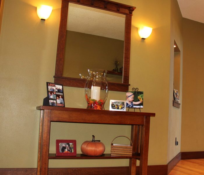 Just inside is a custom made table (made by Dave) that sits below a craftsmen style mirror. The large 4X8 automatic candle is always on it and in the fall season I add leaves to the hurricane sleeve. With some family photo's and a few other sitters the table is complete.