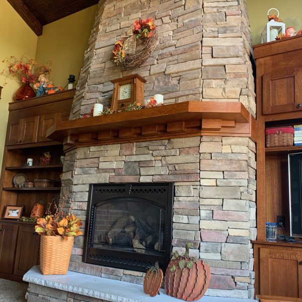 On the hearth I filled a large Longaberger basket with magnolia stems in fall colors, I did have to add height and stuffed a bunch of newspaper in the bottom of the basket to stiffen up the collection as well. The two metal pumpkins add a little something to the other side.