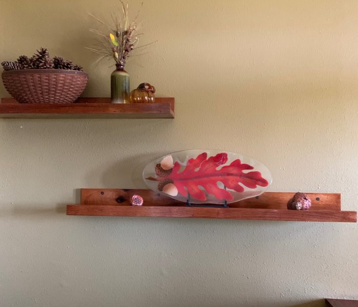 Across from the entry table and above the stairs going down, Dave built me these floating shelves. They are perfect for adding seasonal decor. For fall I love the Peggy Karr Oak Leaf platter with the acorns, add in a Longaberger basket of pinecones and a small vase with a stick of something fall