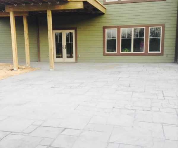 2014 Patio poured with color and stamped. Upper level decking on.